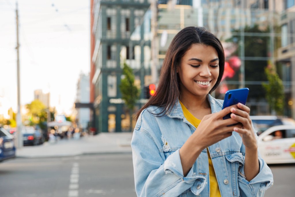 Young woman looking at a map outdoors near train tracks